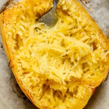 a fork making spaghetti noodles from a roasted squash.