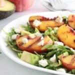 grilled peach salad on a plate.