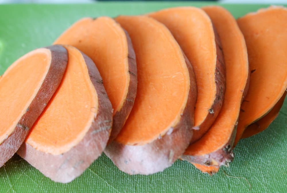 slices of sweet potato on a cutting board.