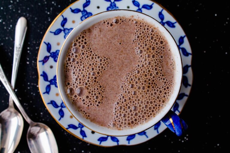 Top down view of a mug full of warm almond milk.