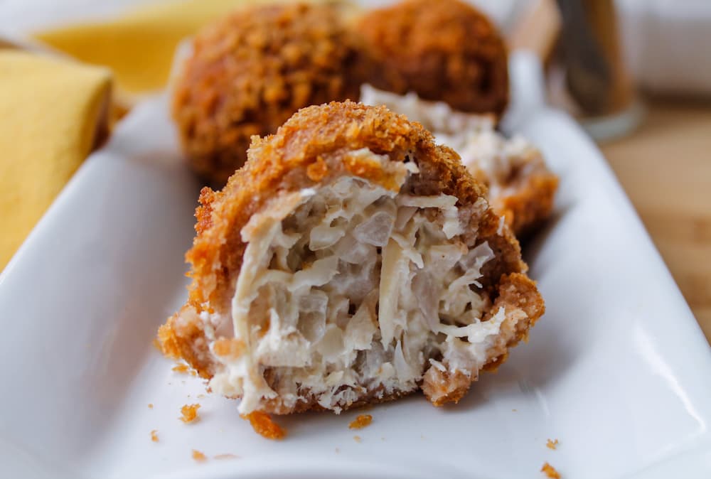 coxinhas on a plate cut in half.