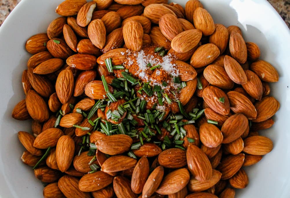 a bow lof almonds with chopped rosemary on top.