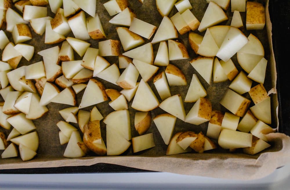 chopped potatoes on a sheet pan.