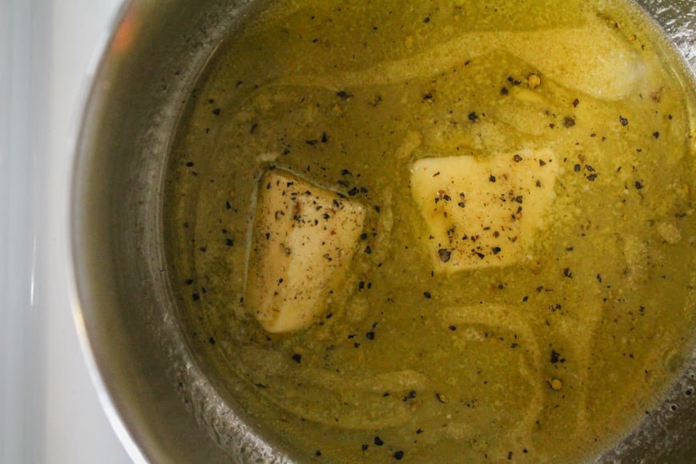 butter and olive oil maleting together in a saucepan.