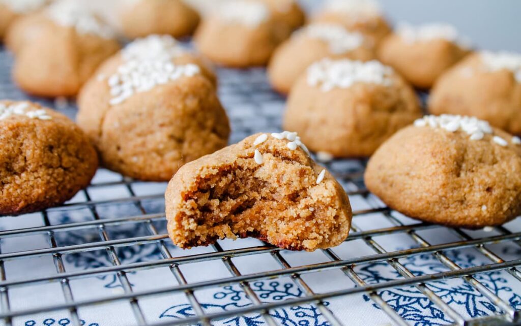 A tahini cookie with a bite out of it.