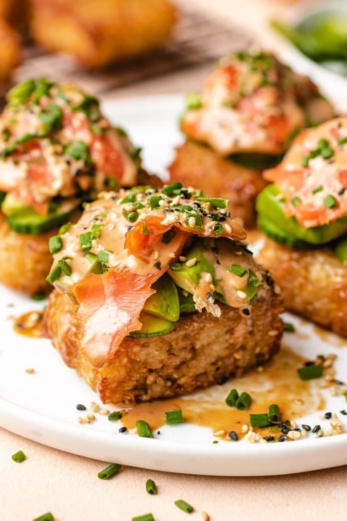 a plate of crispy rice sushi.