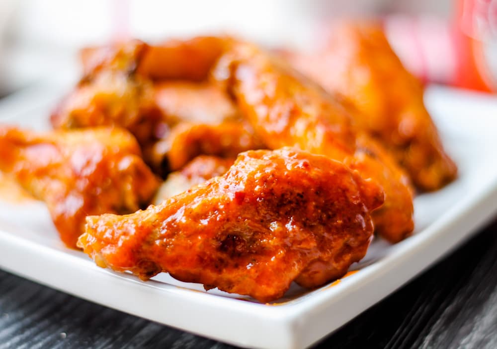 A plate of saucy Oven Baked Chicken Wings.