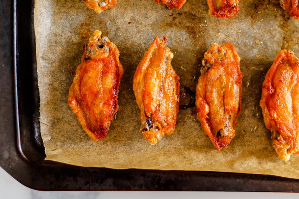 baked wings on a baking sheet.