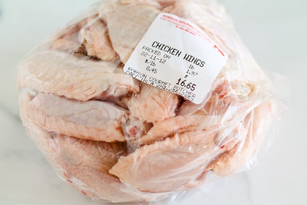a bag of raw chicken wingettes.