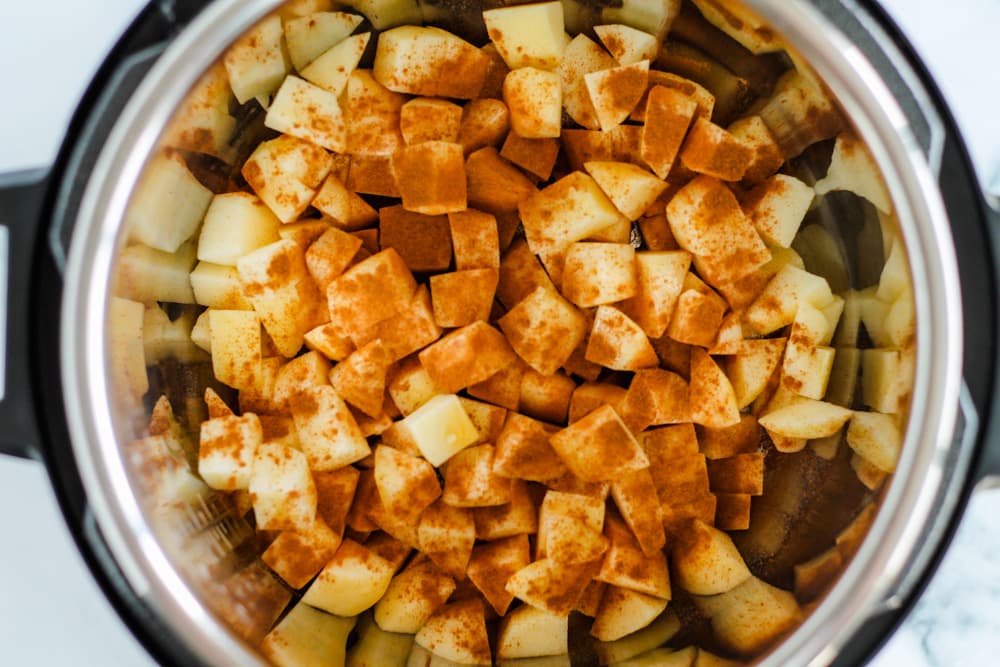chopped apples sprinkled with cinnamon in an instant pot.