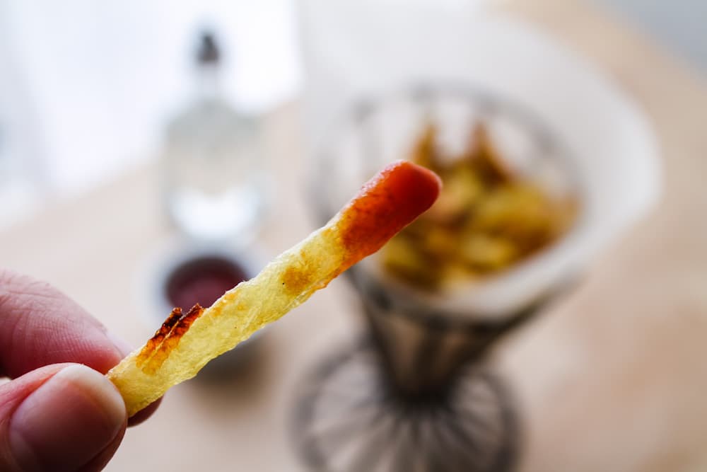 a fry dipped in ketchup.