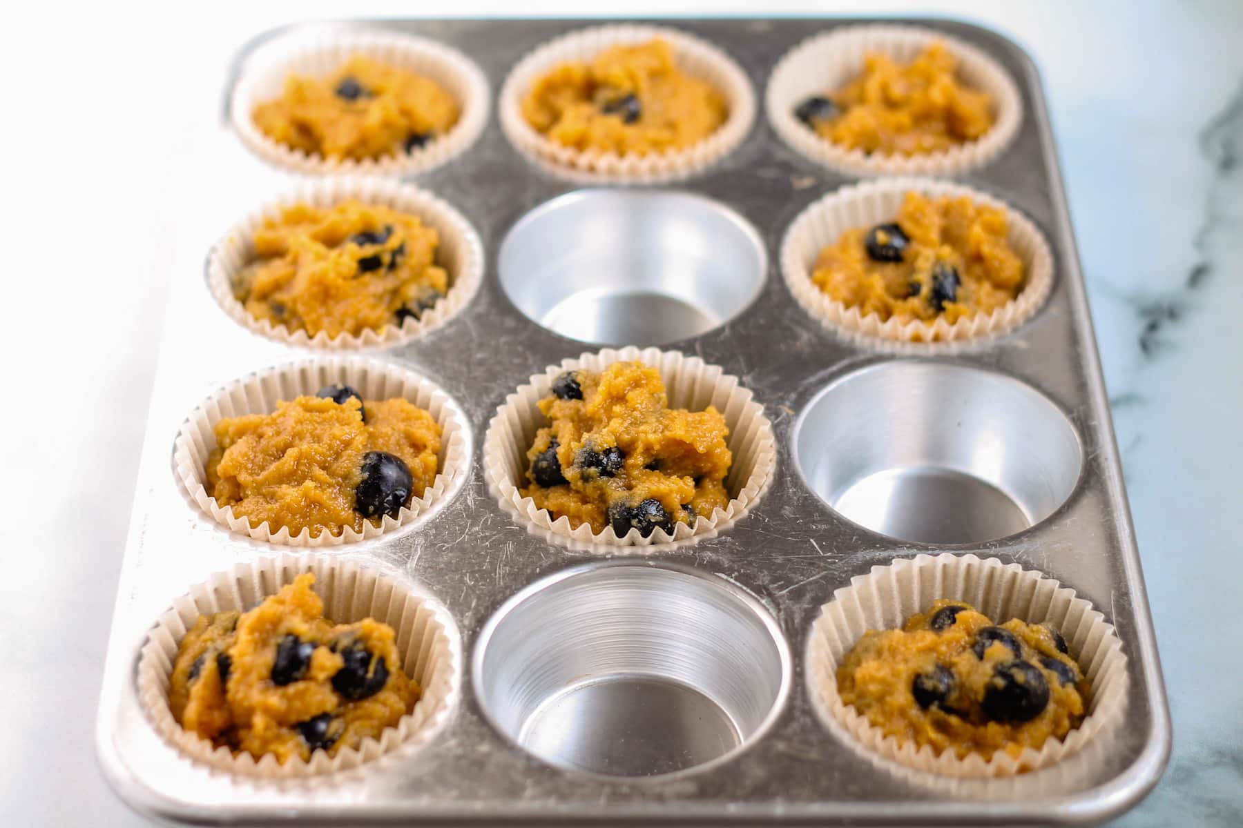 muffin batter in a muffin tin ready for the oven.