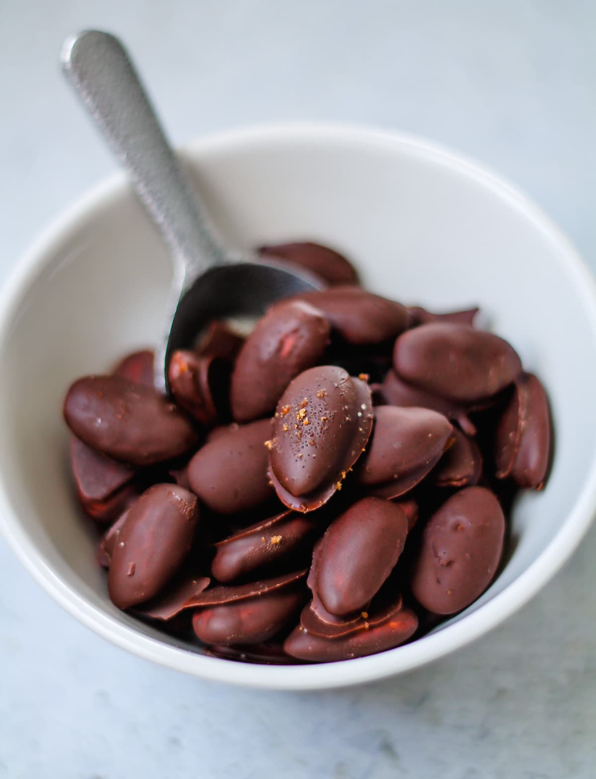 a bowl of homemade chocolate covered almonds.