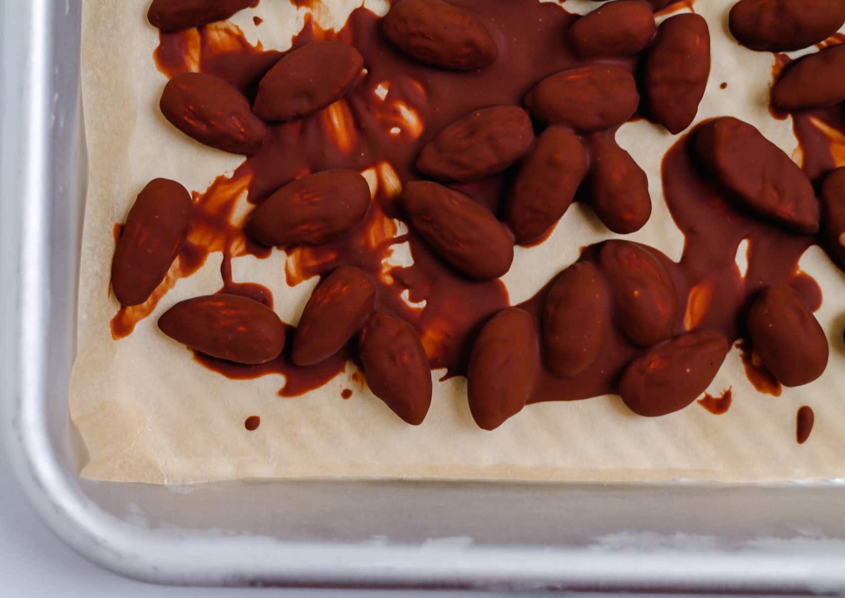 a tray of chocolate covered almonds.