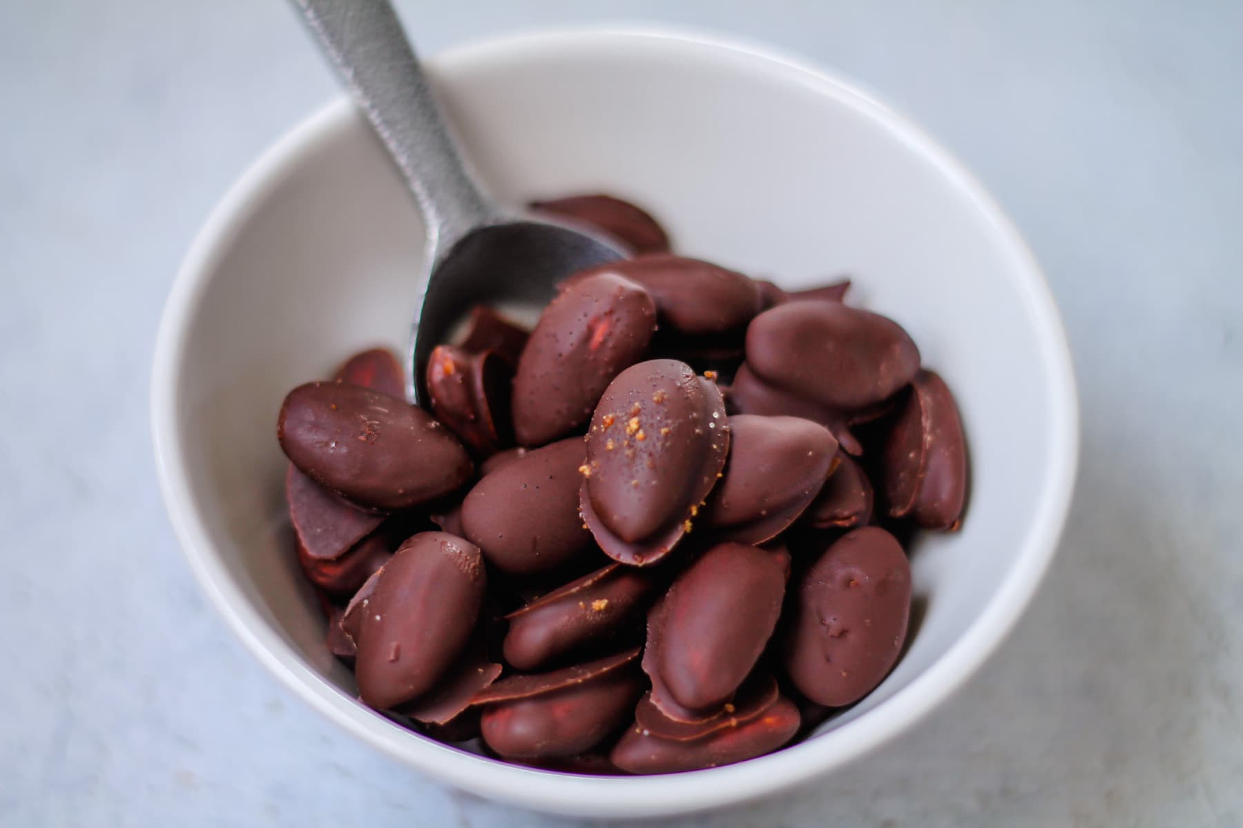 a bowl of homemade chocolate covered almonds.