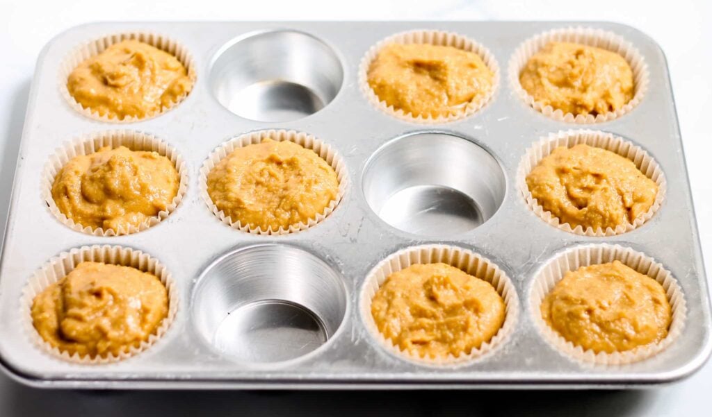 a muffin pan filled with batter.