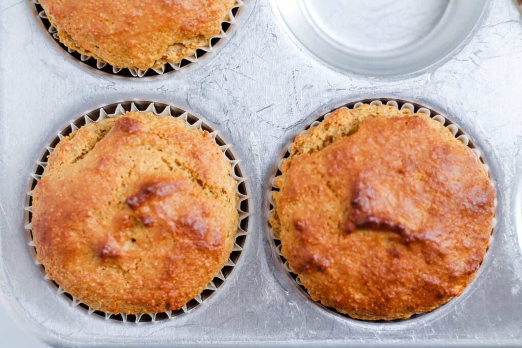 baked muffins cooling in a pan.