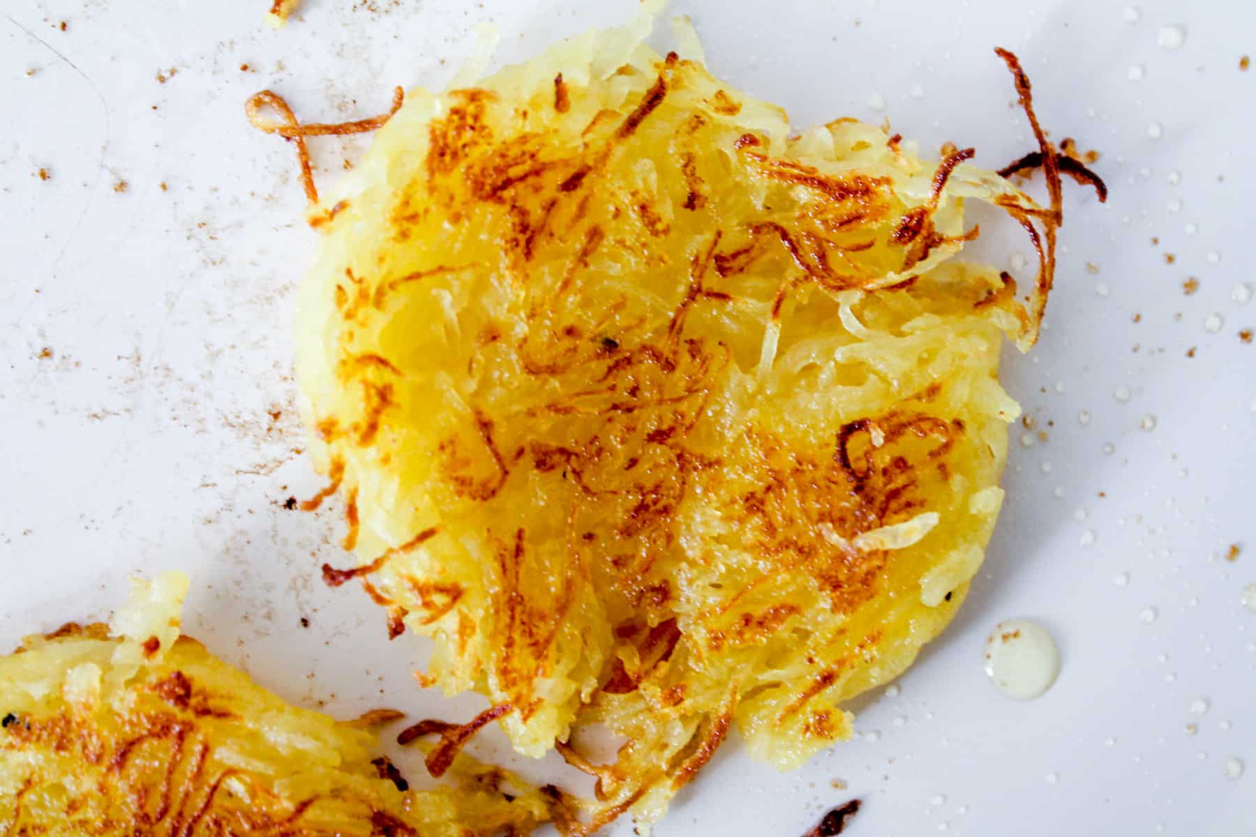 browned spaghetti squash hash browns in a skillet.