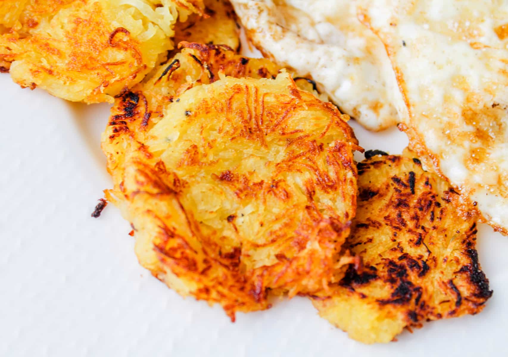 side of spaghetti squash hash browns on a plate.