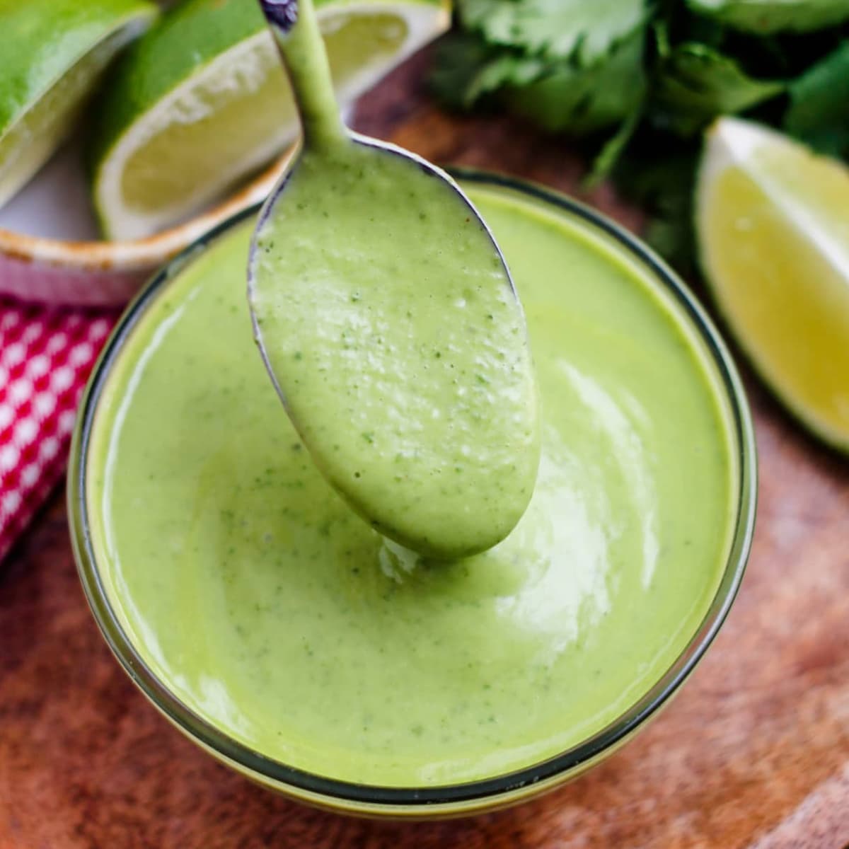 a spoon scooping some avocado cilantro dressing.