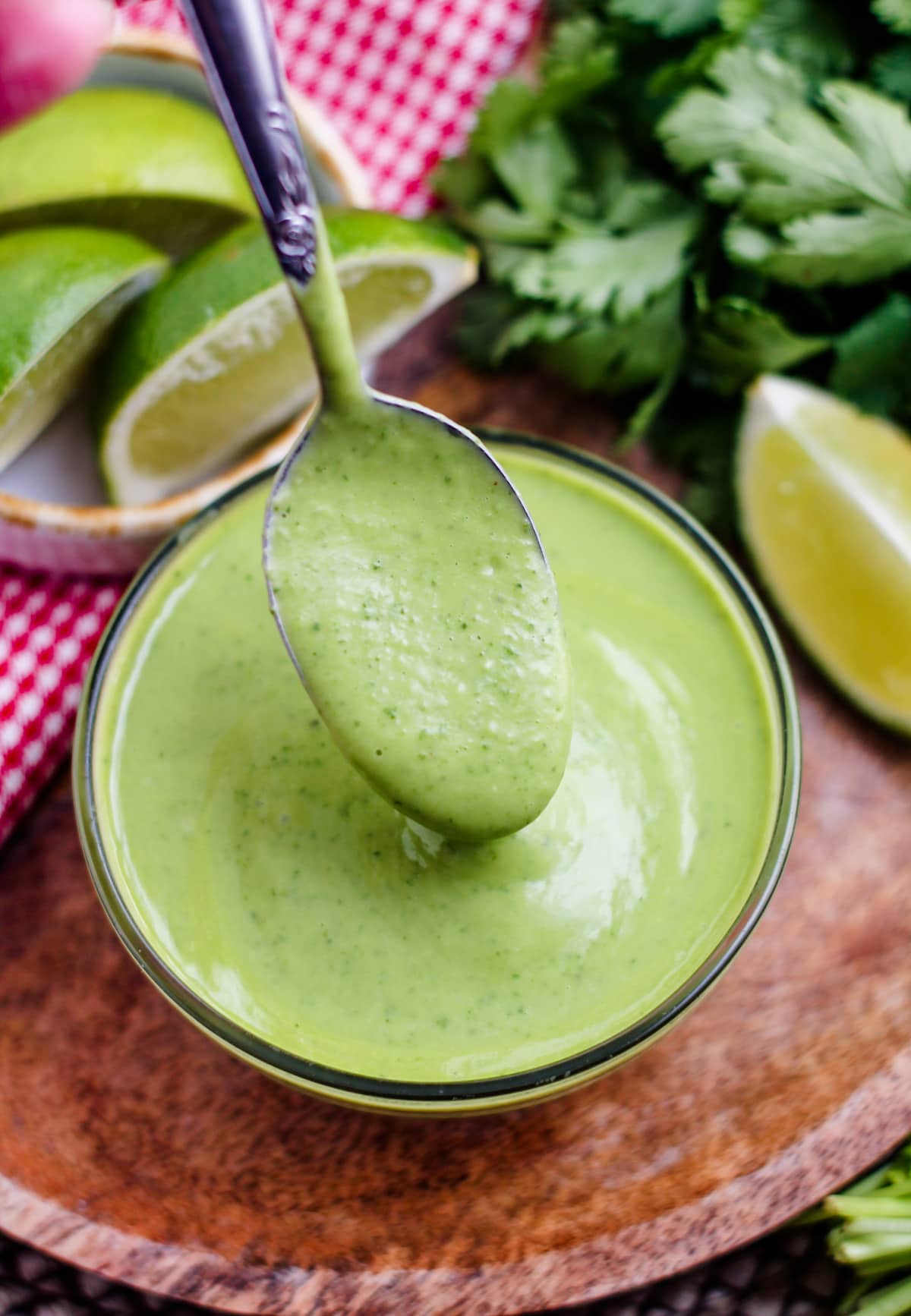 a dish of avocado cilantro dressing with a spoon in it.