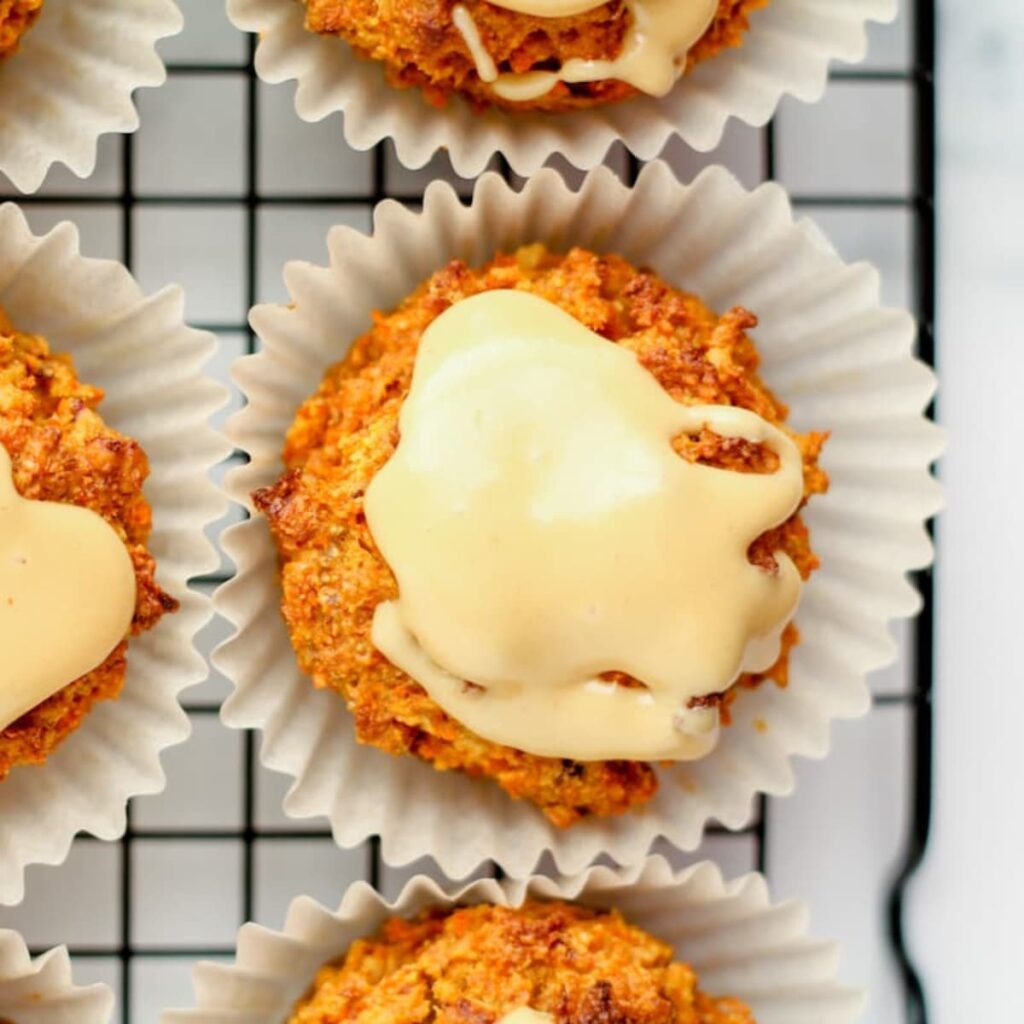 a carrot cake spelt flour muffin on a wire rack.