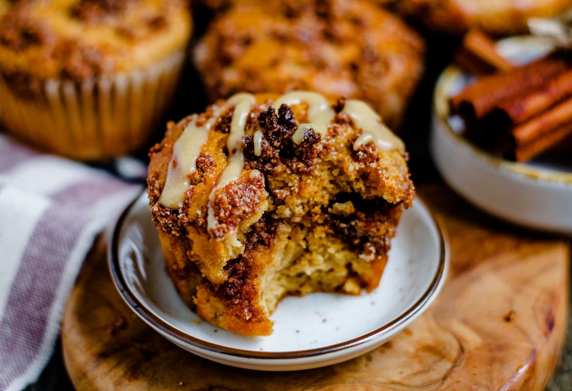 cinnamon roll muffin with a bite out of it.