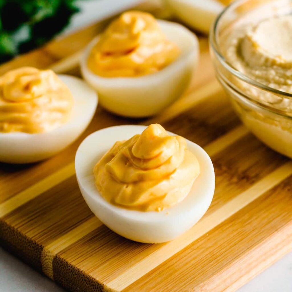 hummus deviled eggs on a serving tray.