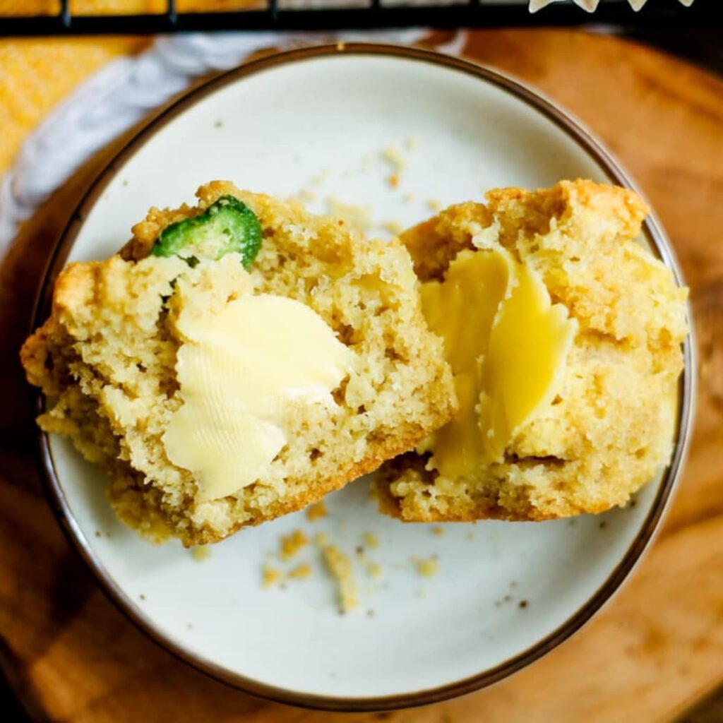 a plate of buttered jalapeno muffins.