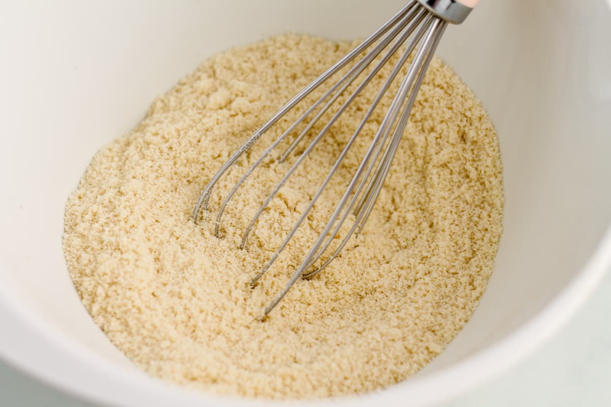 dry ingredients being whisked in a bowl.