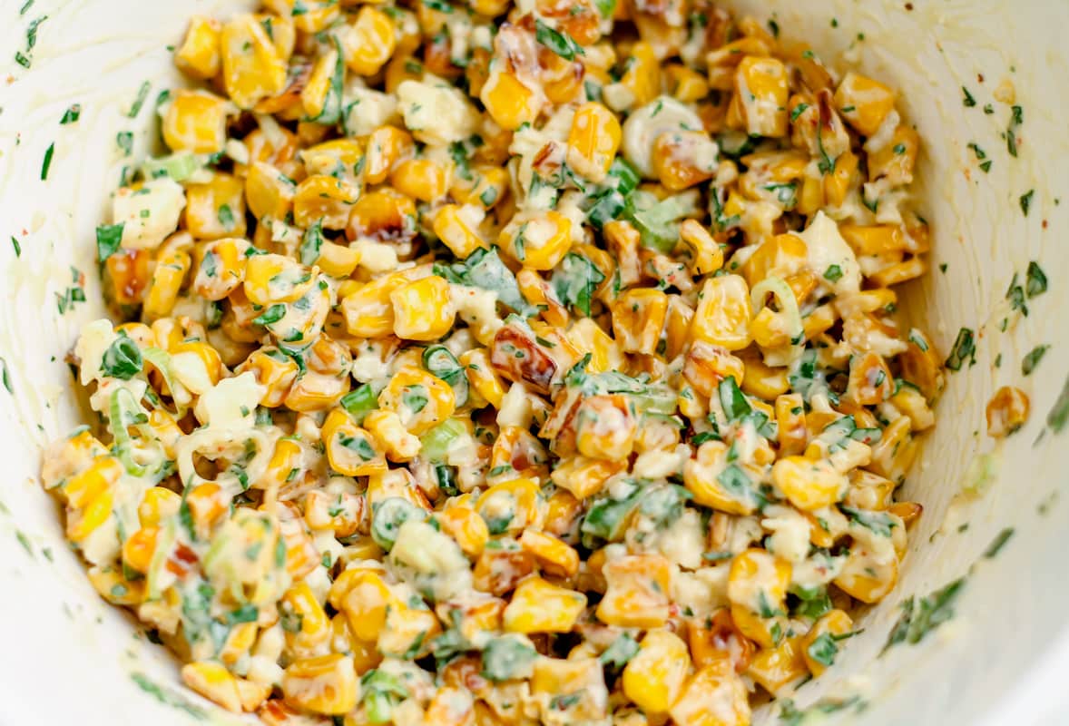 green onions and cilantro tossed with the charred, dressed corn to make Mexican street corn.