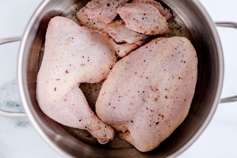 chicken pieces in a large pot.