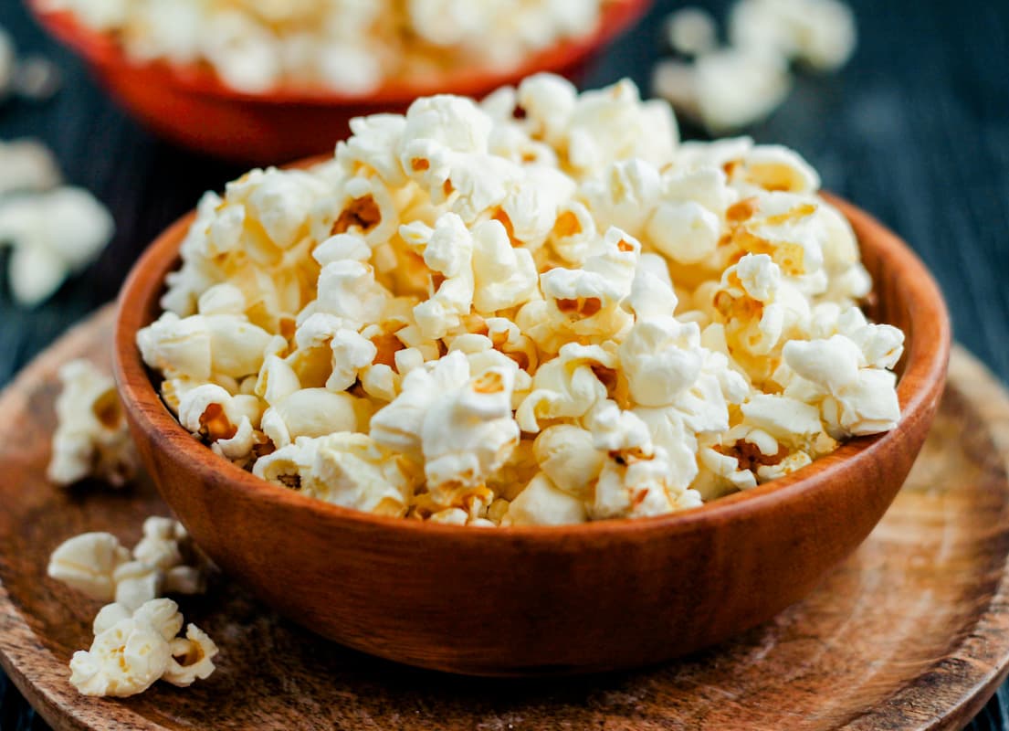 a bowl of coconut oil popcorn on a tray.