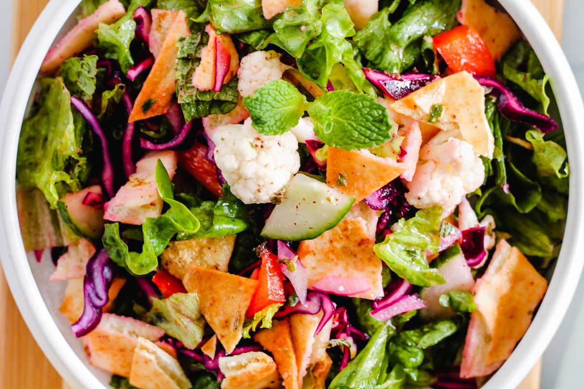 Overhead image of a Fattoush Salad in a white bowl.