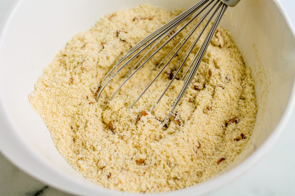 dry ingredients being whisked in a bowl.