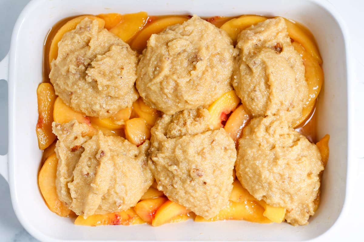 biscuit topping scooped on top of filling in a baking dish.