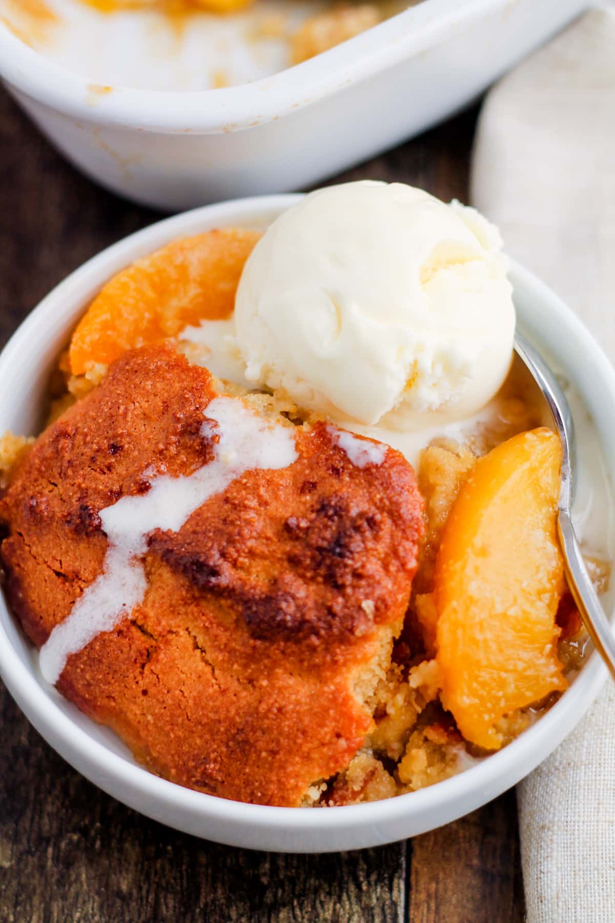 a dish of healthy peach cobbler on a table.