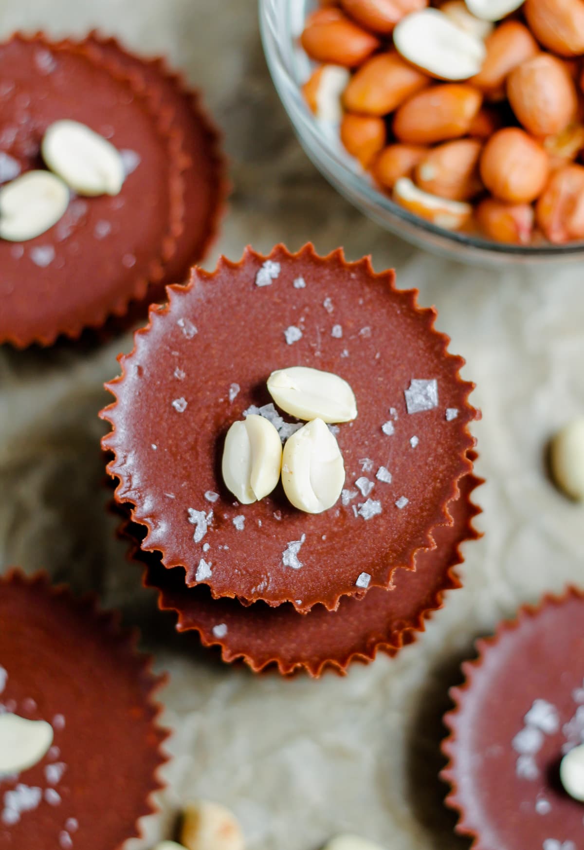 An overhead image of healthy peanut butter cups sprinkled with flaked sea salt. 