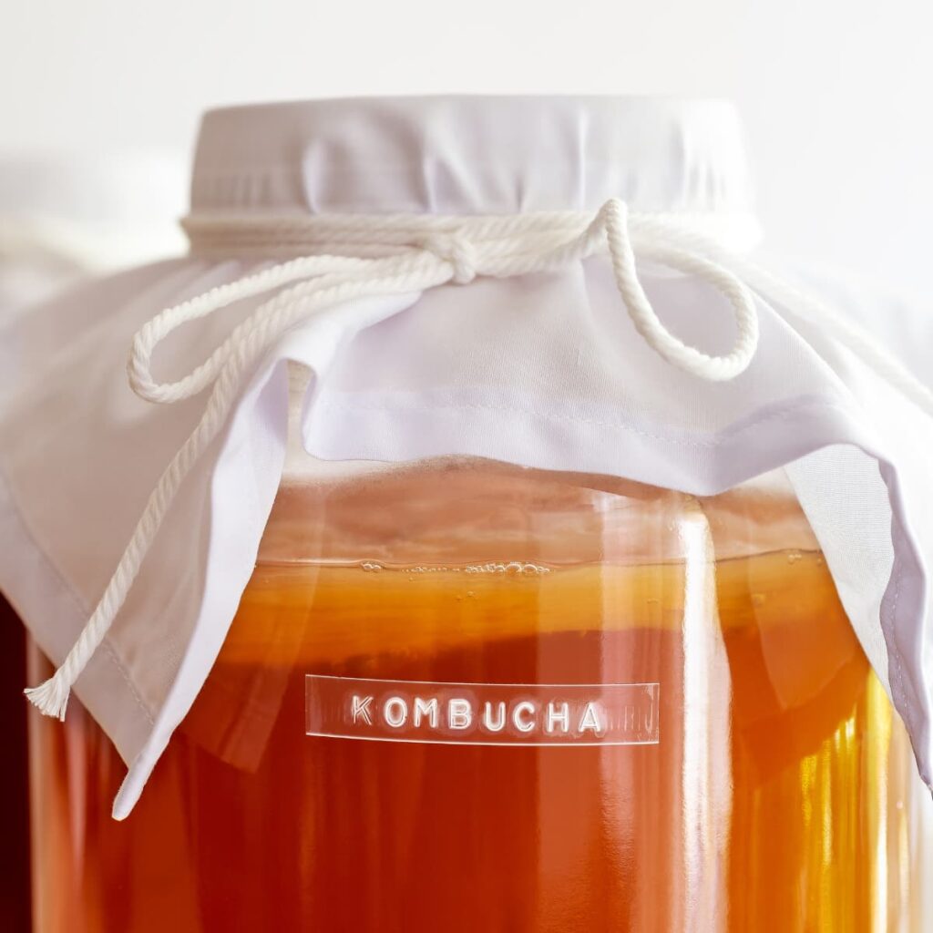 A jar of kombucha with a label on the front.