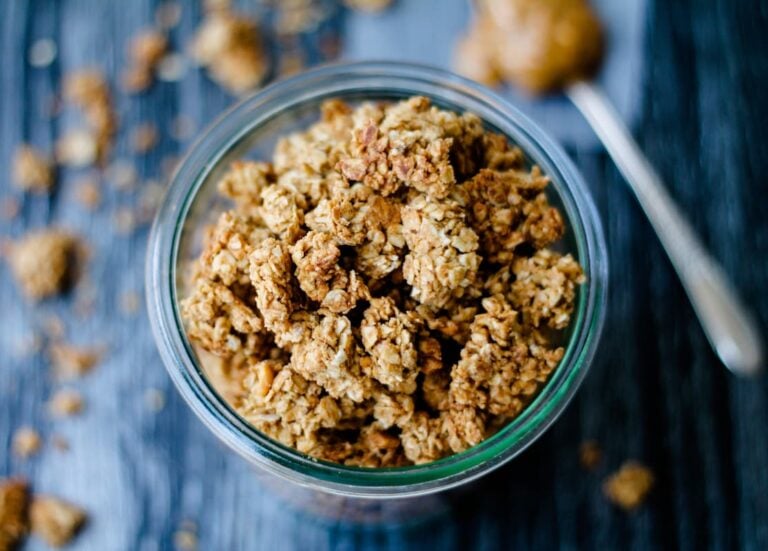 Overhead image of peanut butter granola in a glass jar.