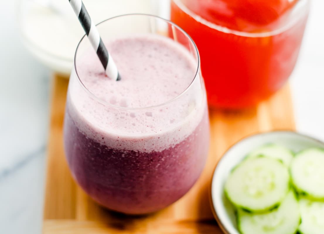 A probiotic smoothie in a glass on a wooden board.