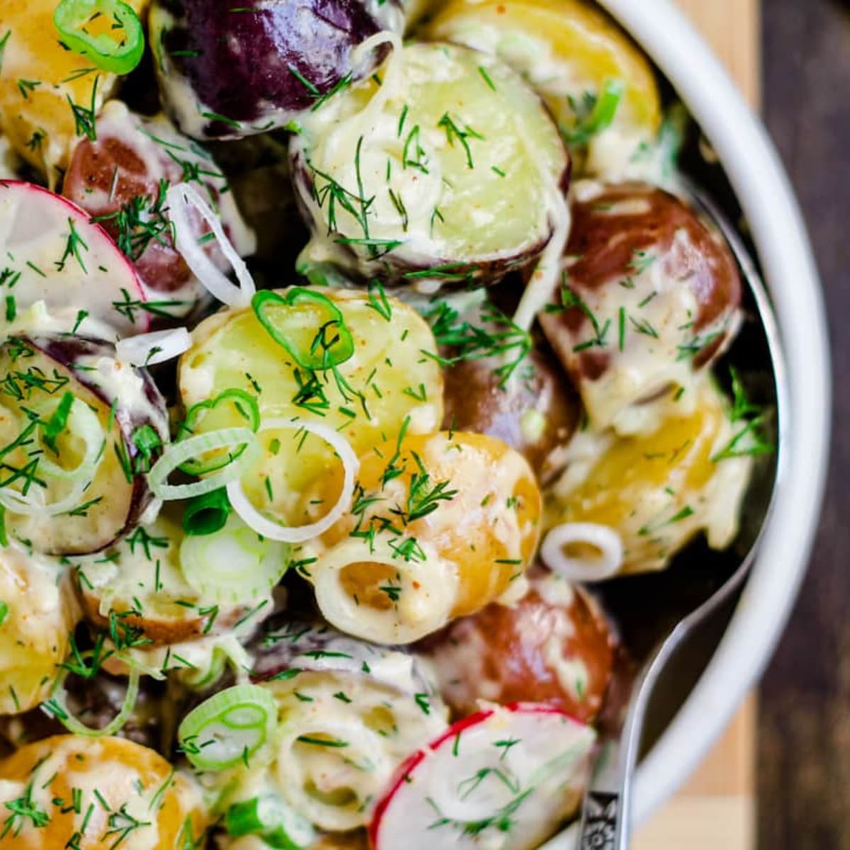 a bowl of spring onion potato salad.