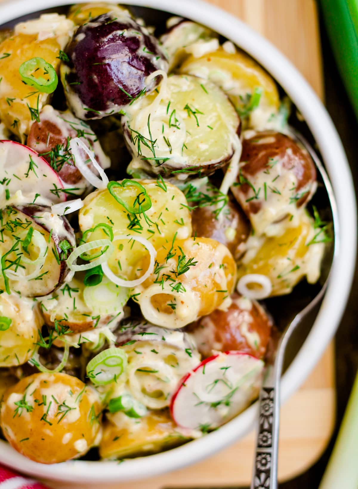 spring onion potato salad in a bowl.