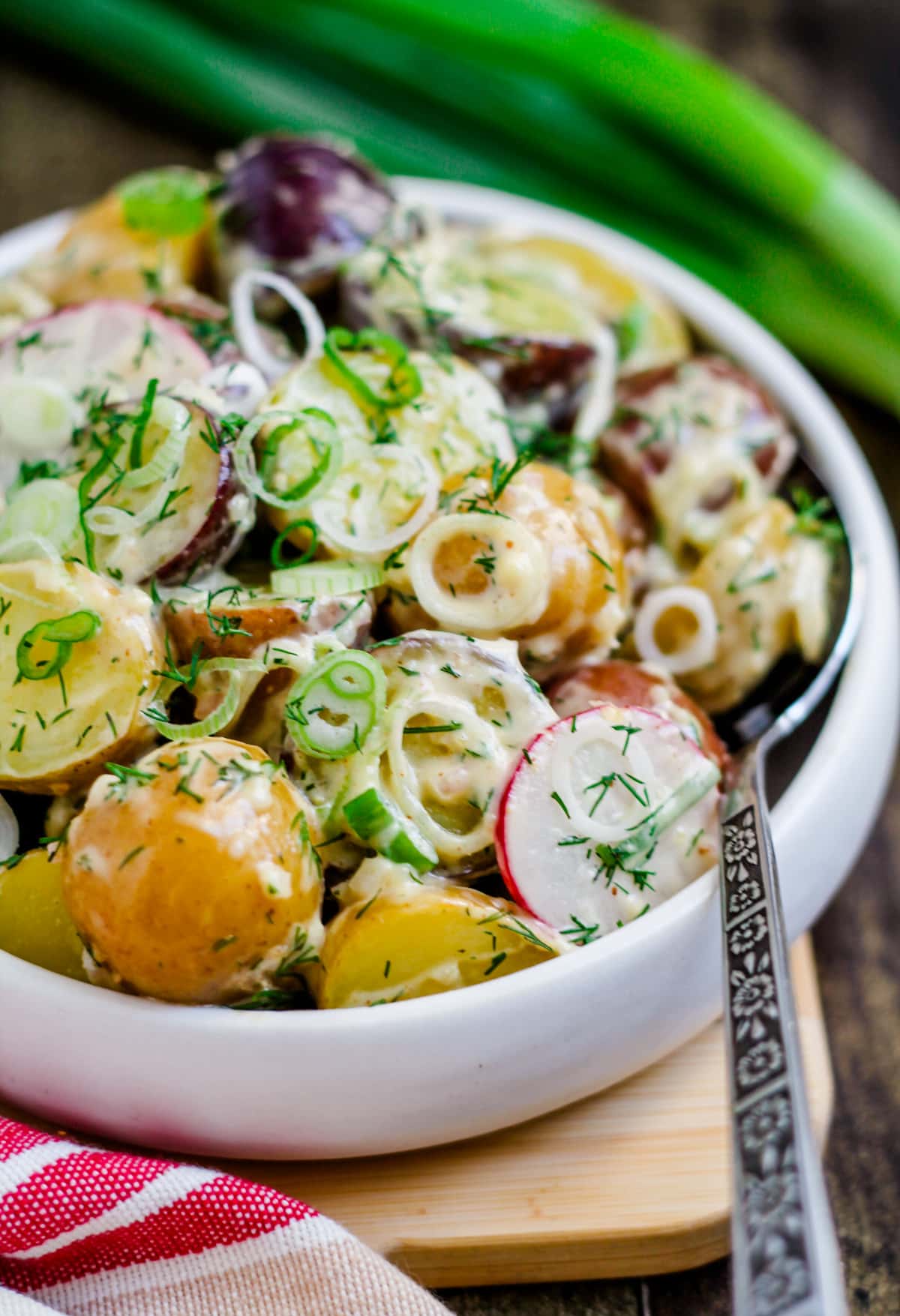 spring onion potato salad on a table.