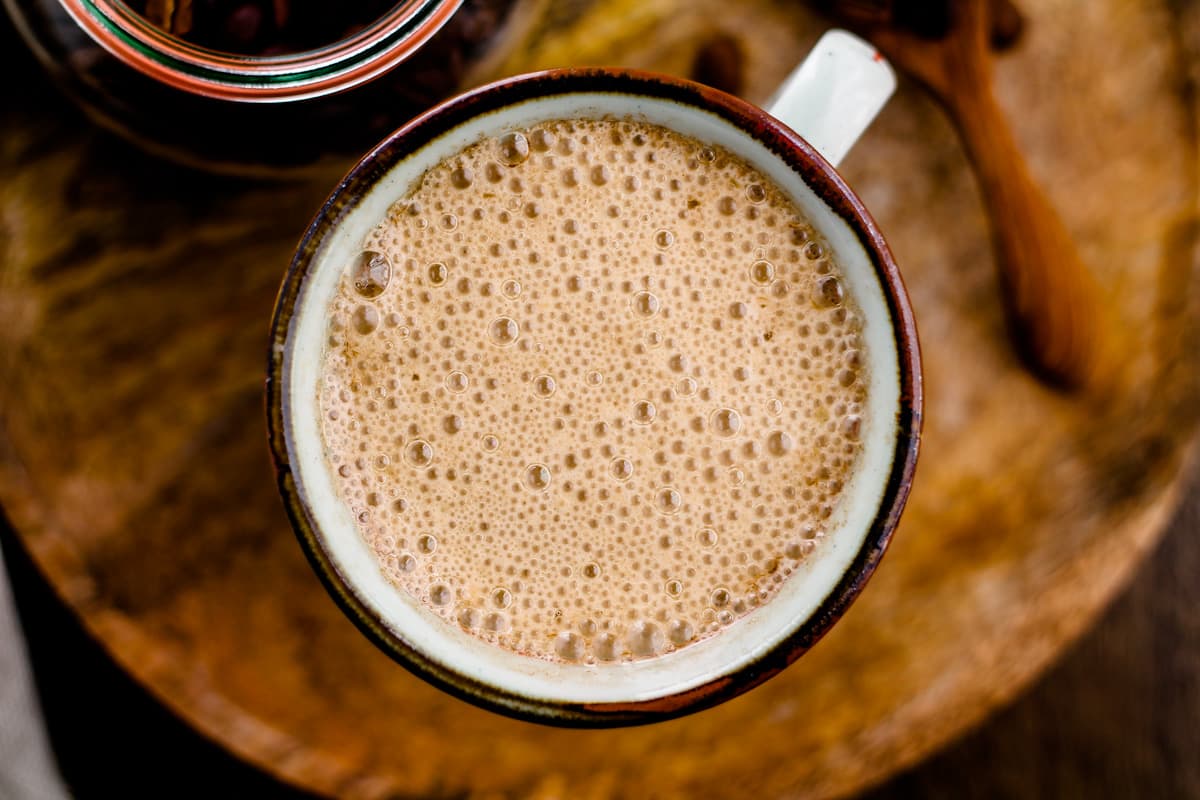 An overhead image of Vegan Bulletproof Coffee in a brown mug.