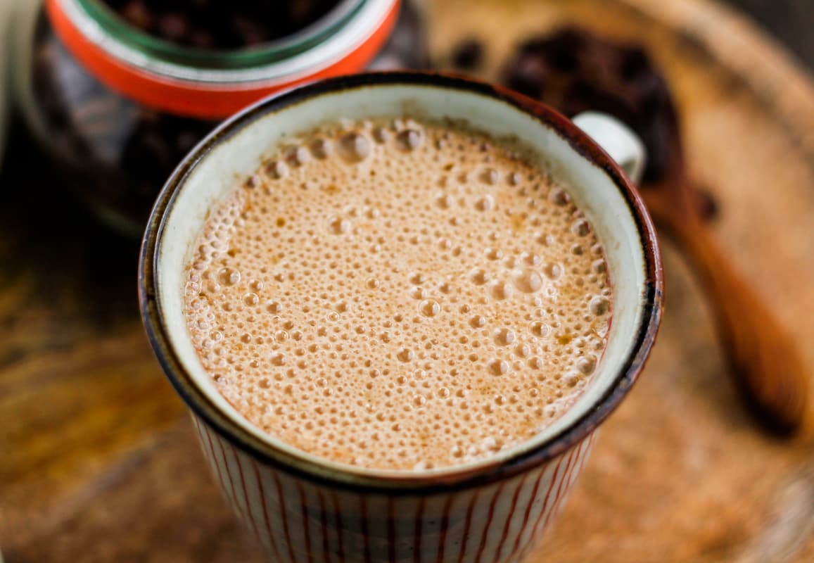 Overhead image of a mug filled with creamy Vegan Bulletproof Coffee.