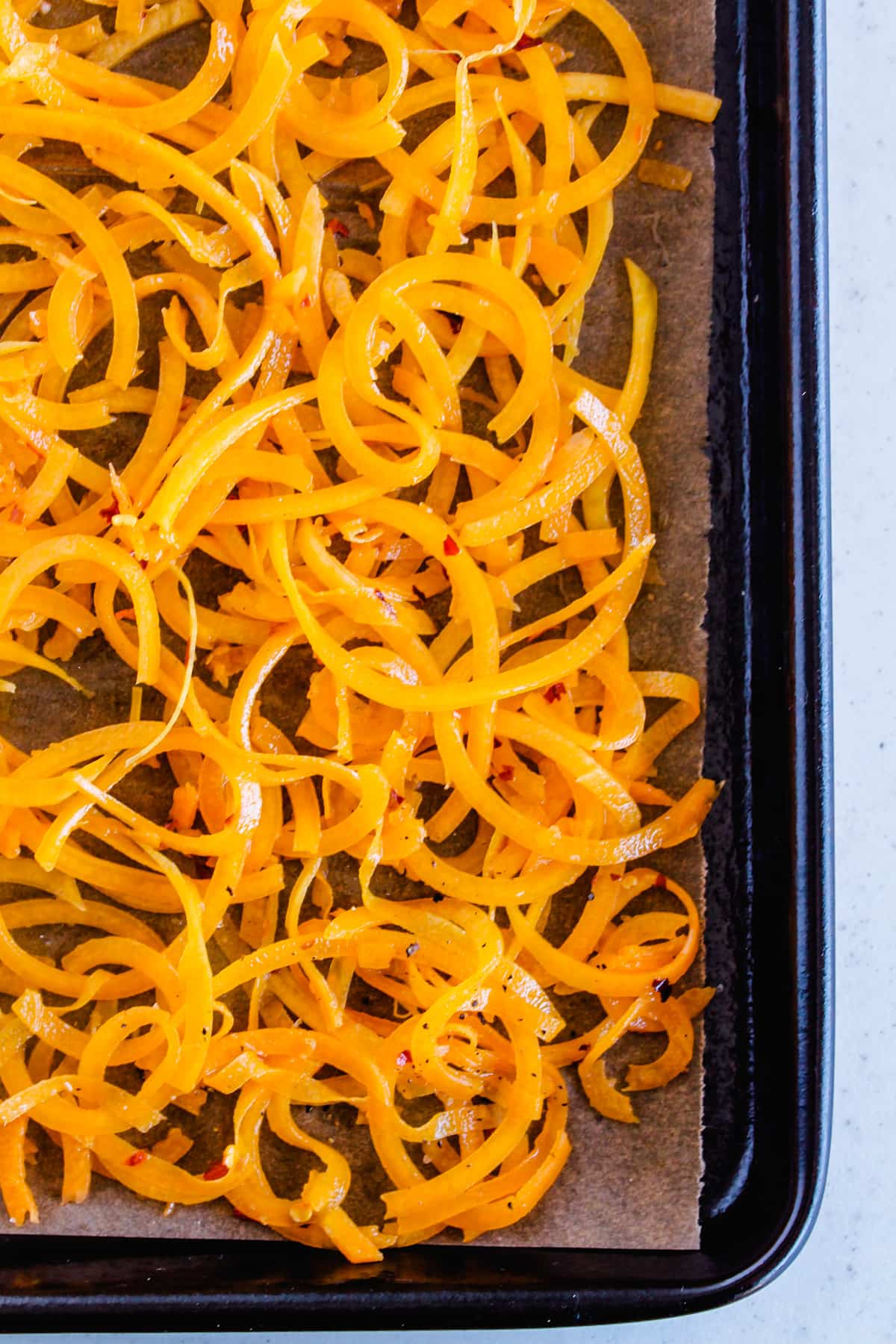 Veggie noodles on a baking tray.