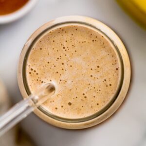 An overhead image of a banana almond butter smoothie.