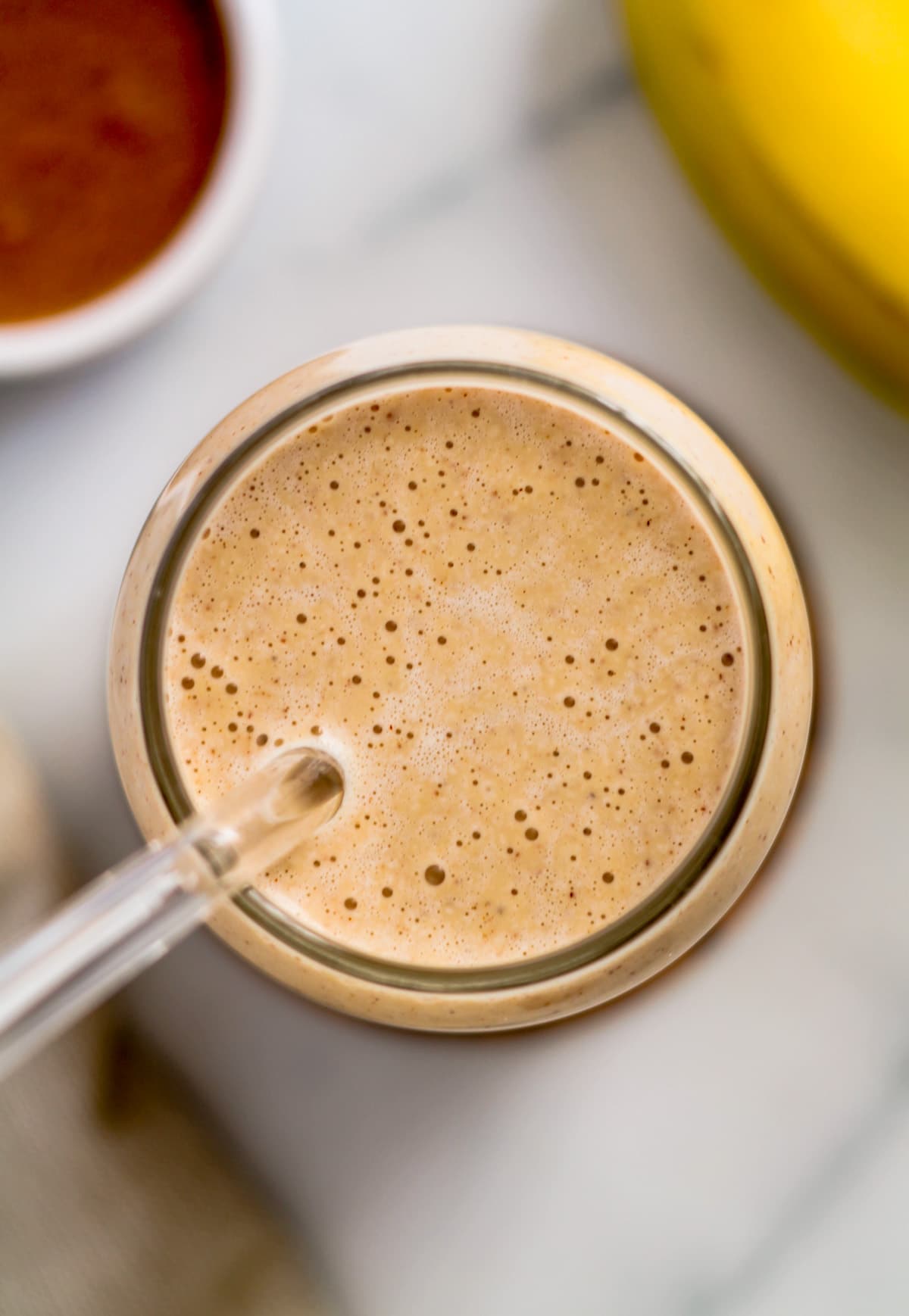 An overhead image of a banana almond smoothie.