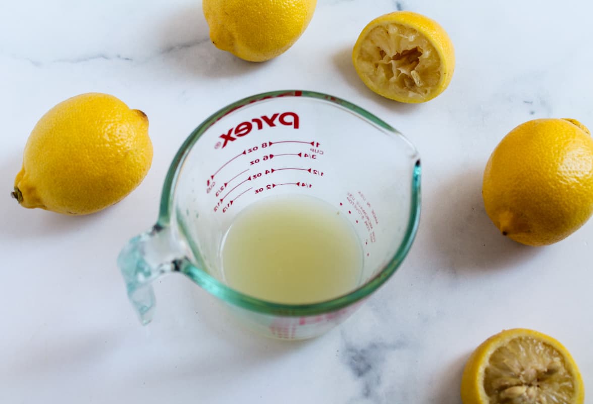 A glass jar of freshly squeezed lemon juice.